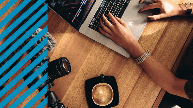 persona con maglietta nera e bracciale scrive sulla tastiera del pc. caffè a fianco e linee blu sullo sfondo